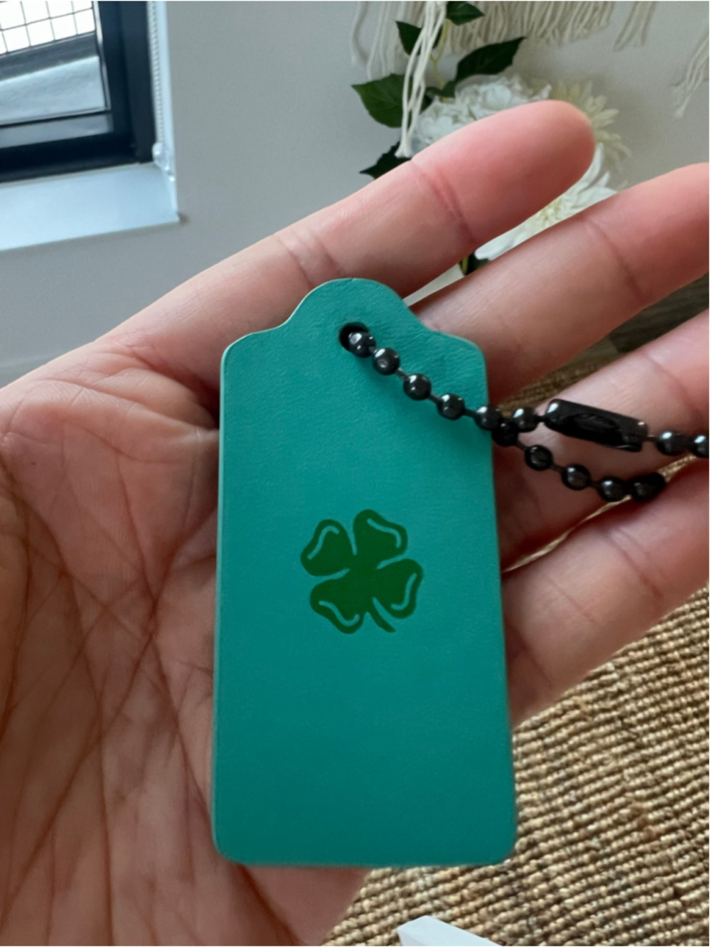 Teal Coach leather hangtag with green four-leaf clover St Patrick’s Day Lucky